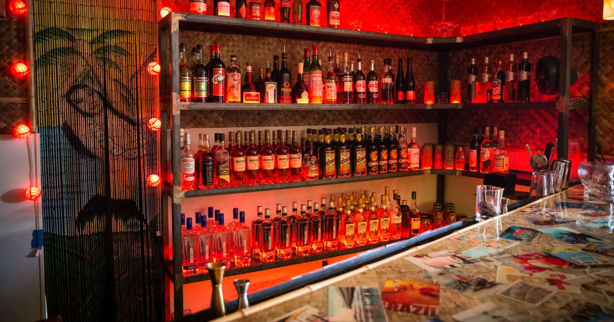 Tiki bar interior in Palm Springs with dim lighting, tropical decor, and neon signs