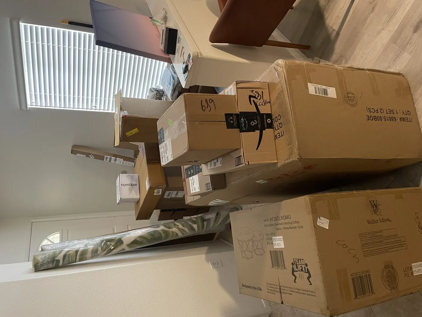 Staging supplies and decor boxes arriving at vacation rental during photo shoot preparation week