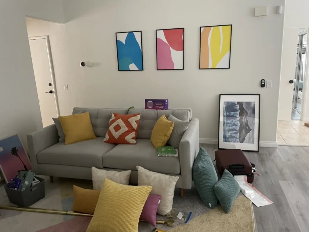 Throw pillows in various combinations during vacation rental staging process for photography