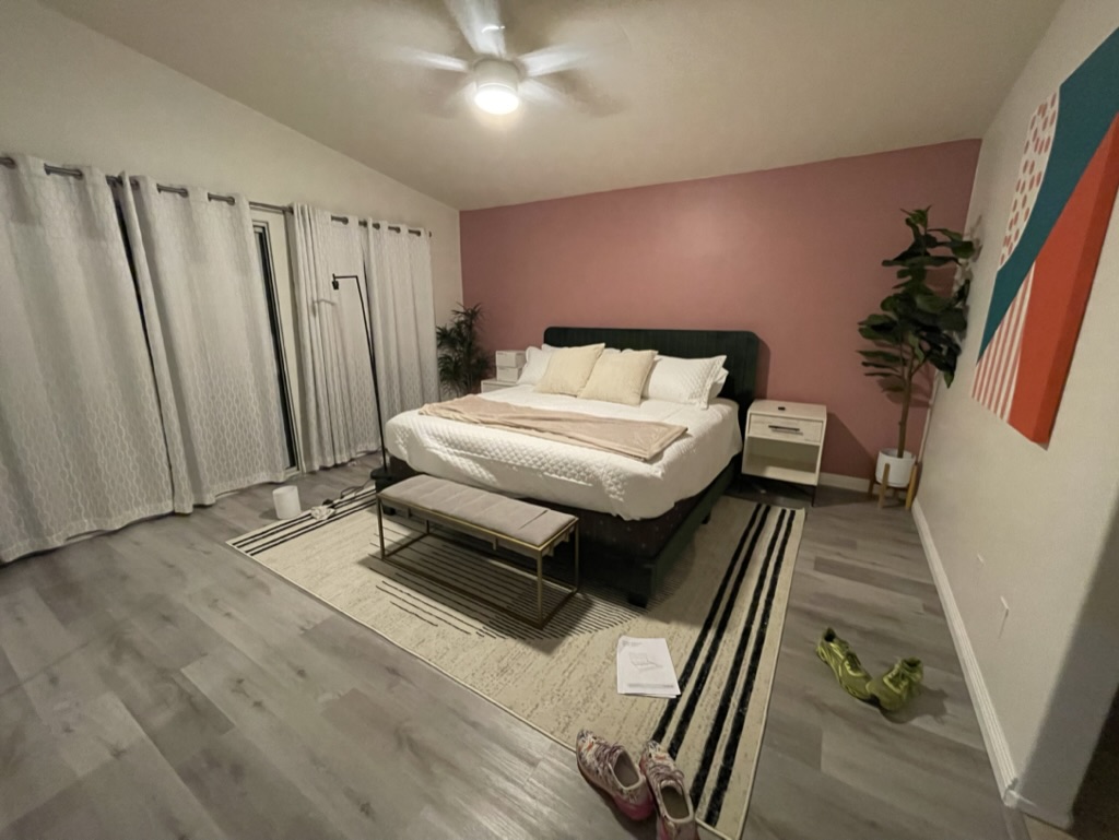 Primary bedroom at a Coachella Valley vacation rental styled with warm desert tones and quality linens