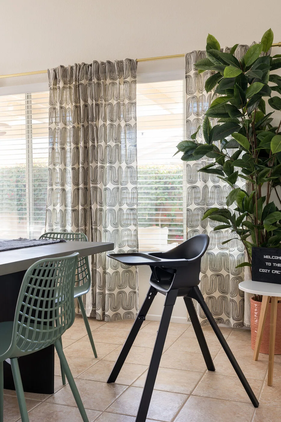 Stokke high chair at The Cozy Cactus dining area with modern curtains and fiddle leaf fig plant