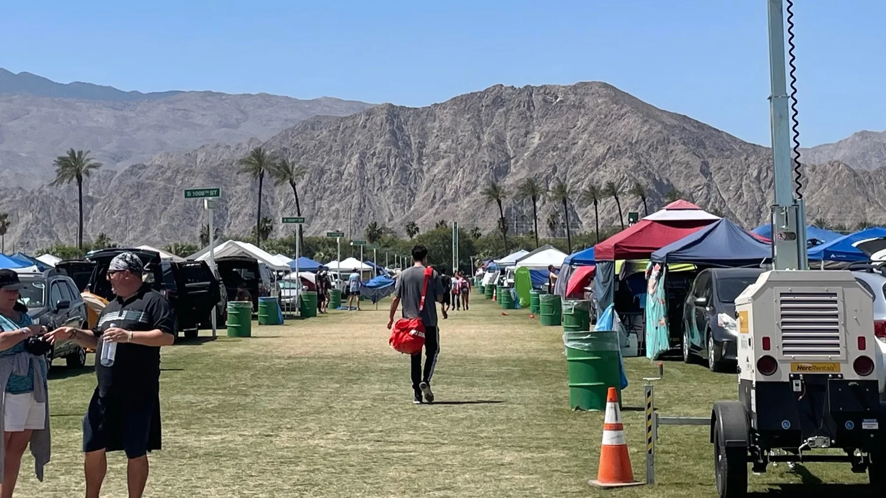 Coachella festival camping area with rows of tents and cars in the desert campground at Indio California