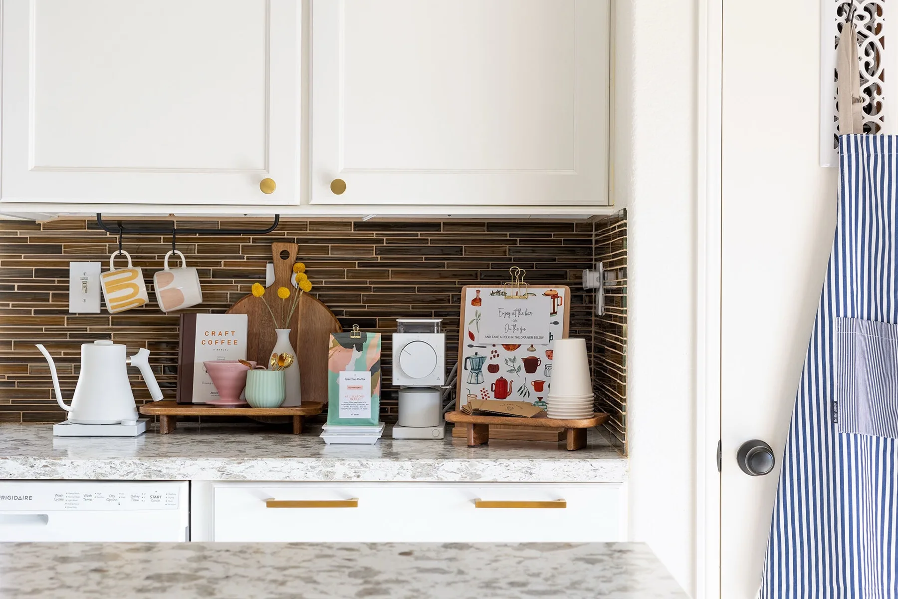 Coffee bar setup with pastries and espresso equipment in a desert home