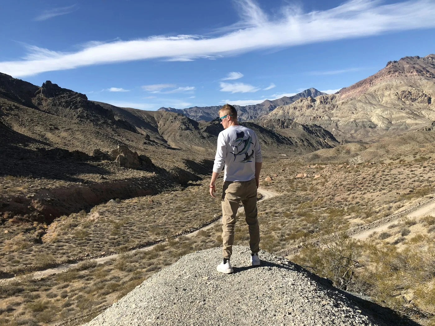 Hikers on a desert ridge trail above the Coachella Valley with expansive views below