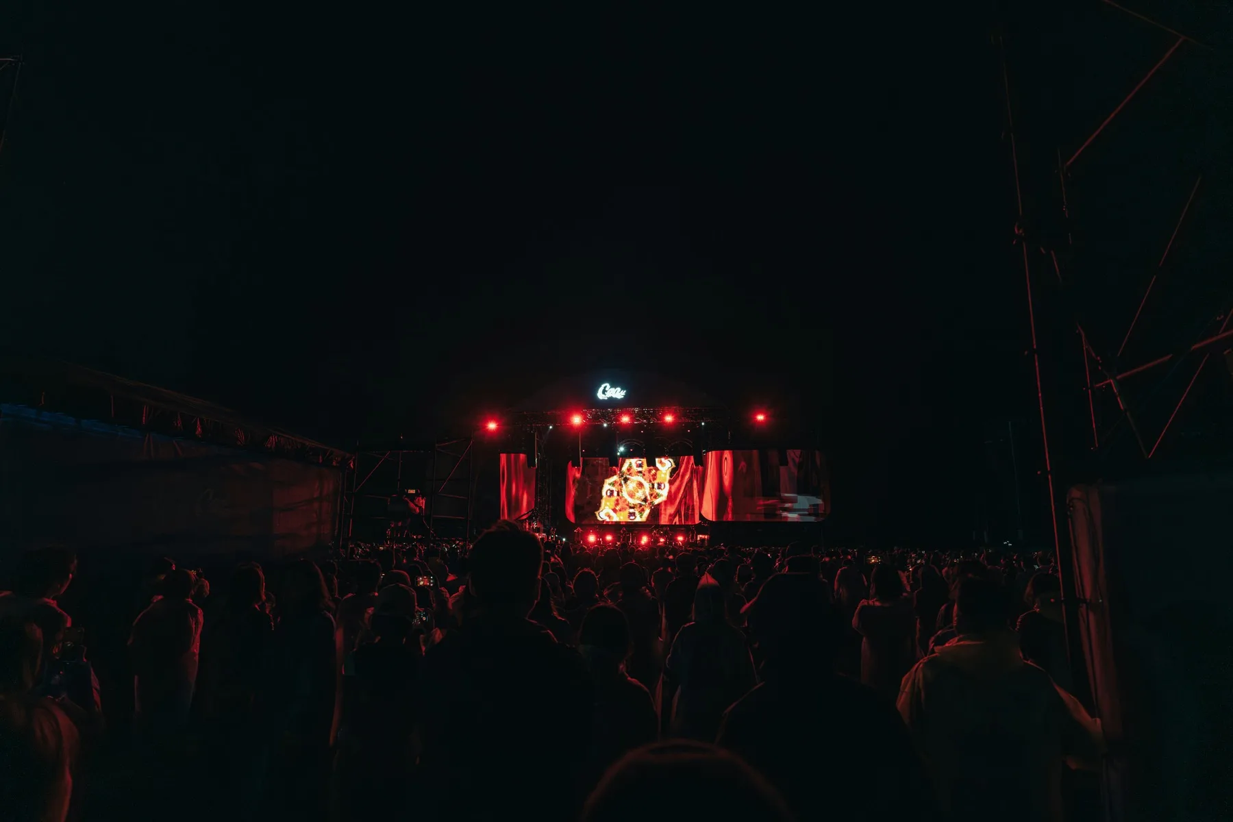 Crowd watching a live concert performance on stage at night