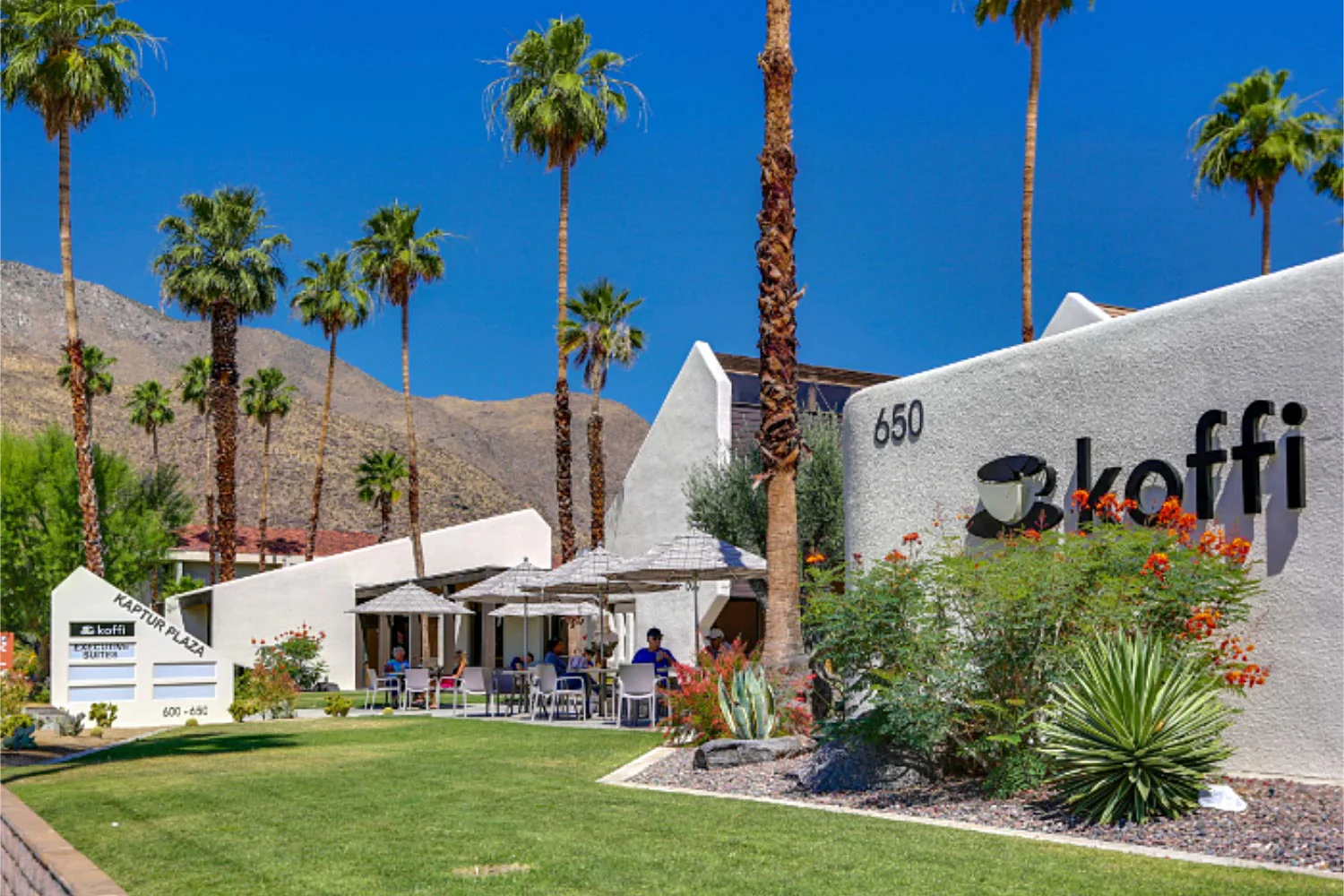 Koffi coffee shop exterior in Palm Springs with palm trees and mountain backdrop