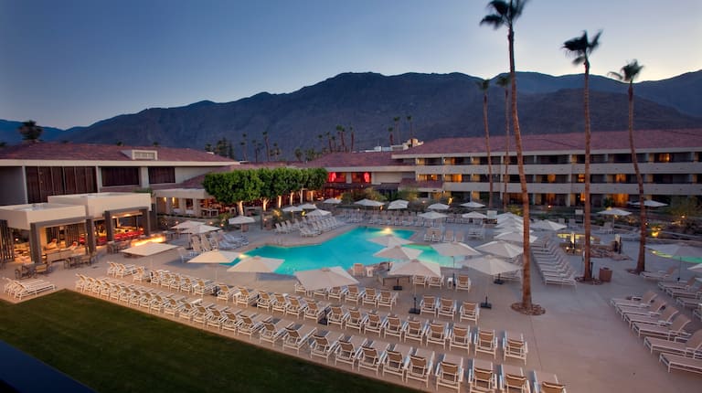 Pool at a Palm Springs hotel with lounge chairs and desert landscape