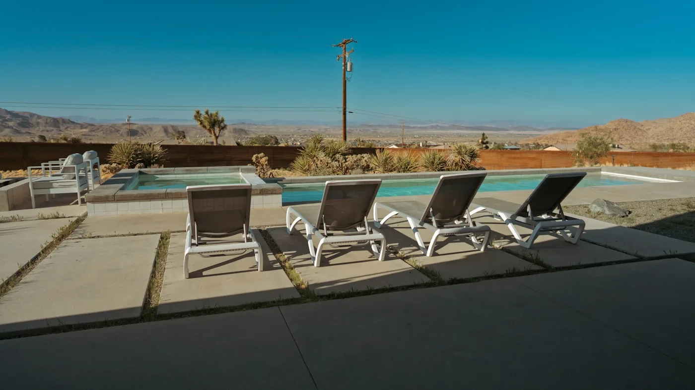 Palm Springs pool at golden hour with desert mountains in the background