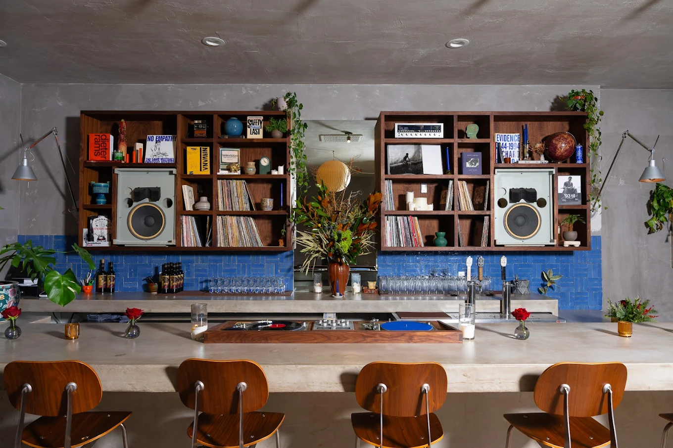 Rosemary HiFi bar interior, cobalt blue tile, walnut shelving with vinyl records, 1960s JBL speakers, concrete bar, Indio CA