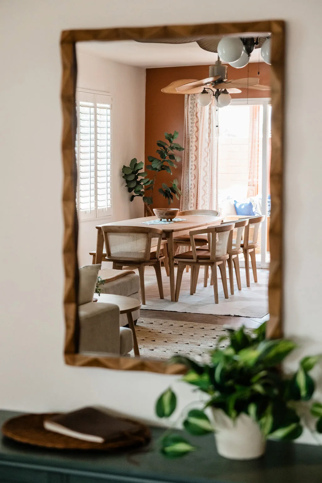 Terra Luz dining room with dining table for eight, Cuban artwork, and warm pendant lighting in Indio California