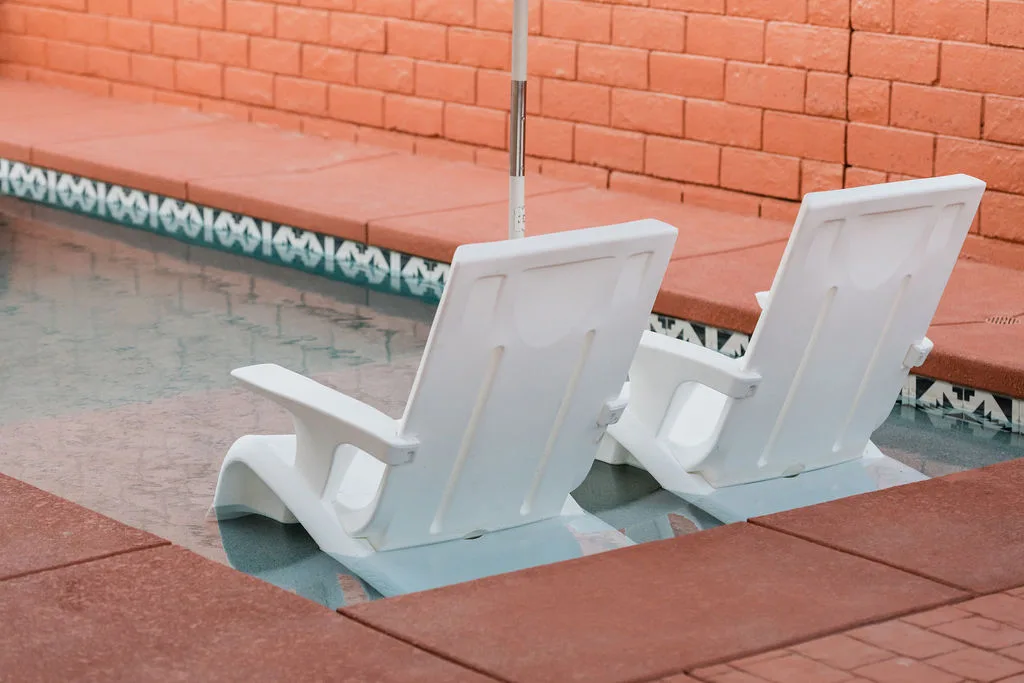 Terra Luz pool and backyard in Indio California with outdoor lounge, blue and white umbrella, and Kahlo blue pool