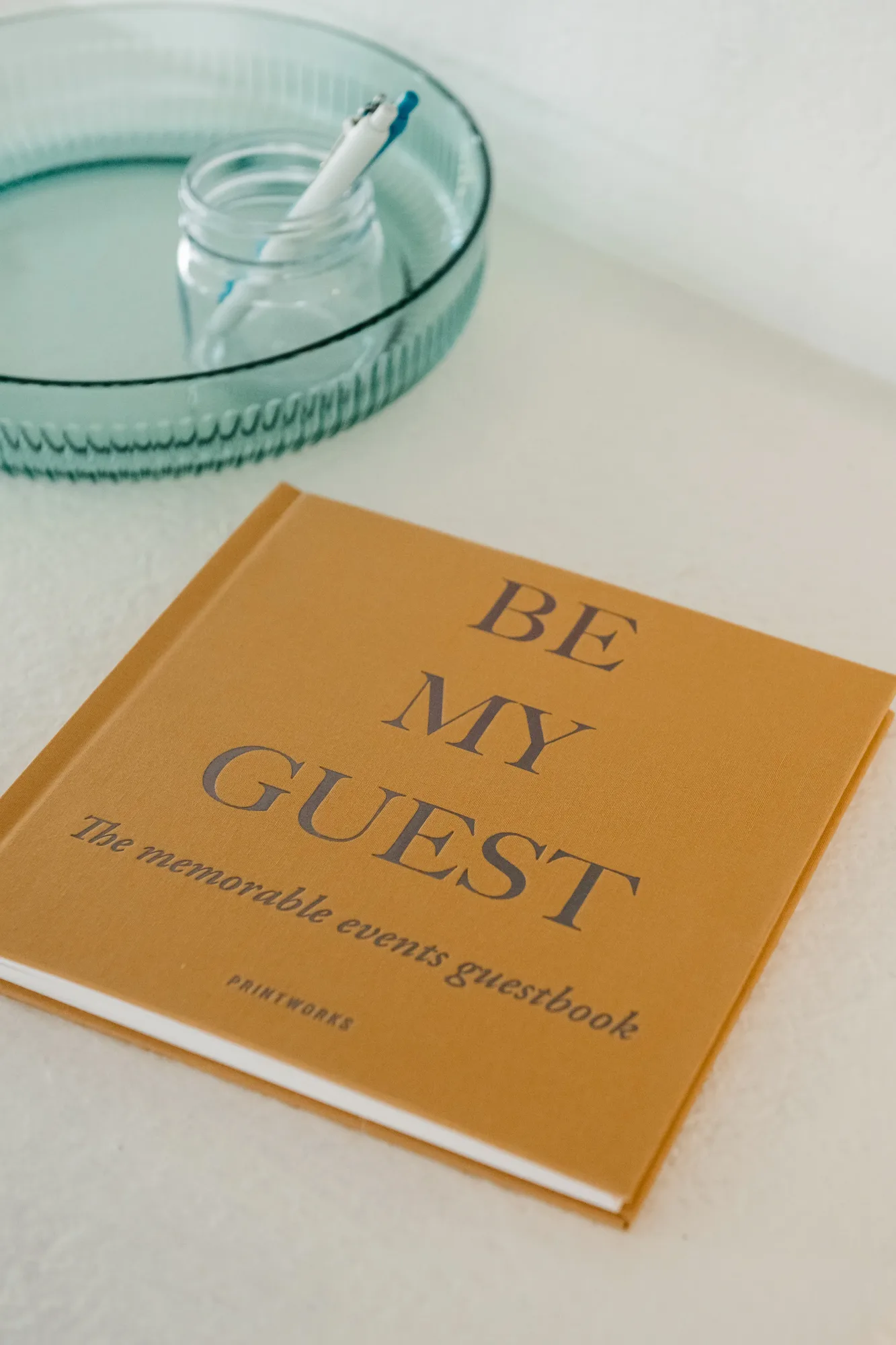 Printworks Be My Guest guestbook and glass tray on nightstand at Cozy Cactus Indio vacation rental