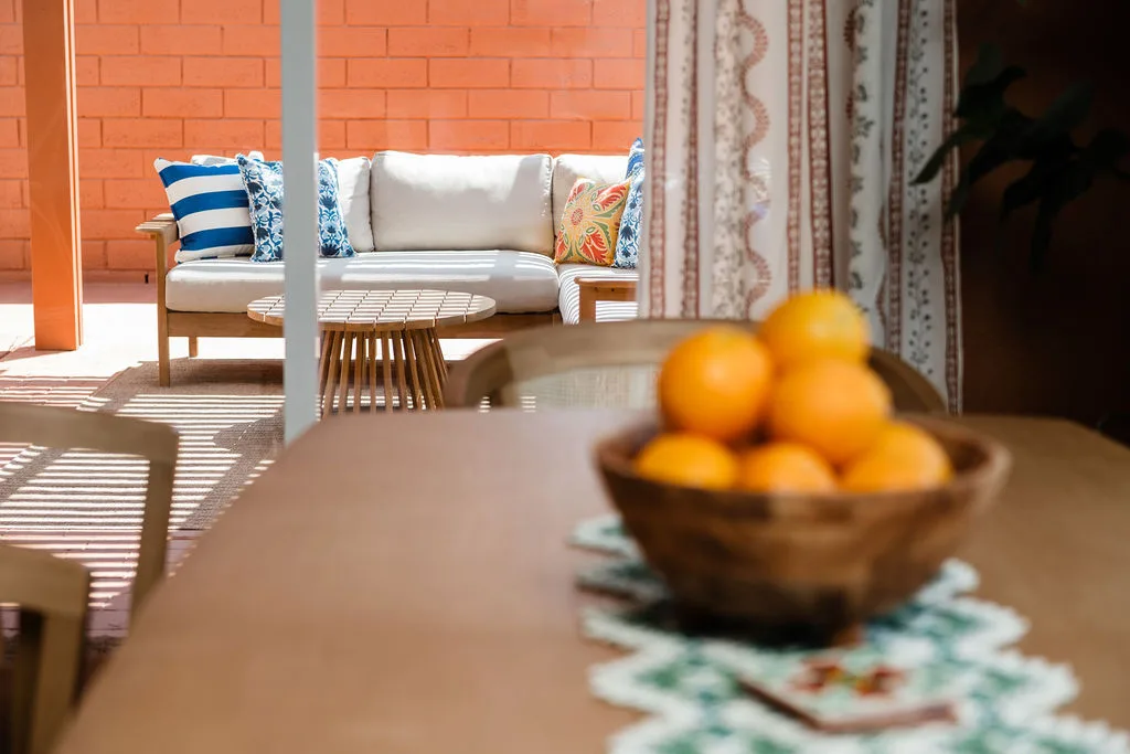 Terra Luz kitchen nook entry with capiz shell pendant and warm Caramel Apple walls