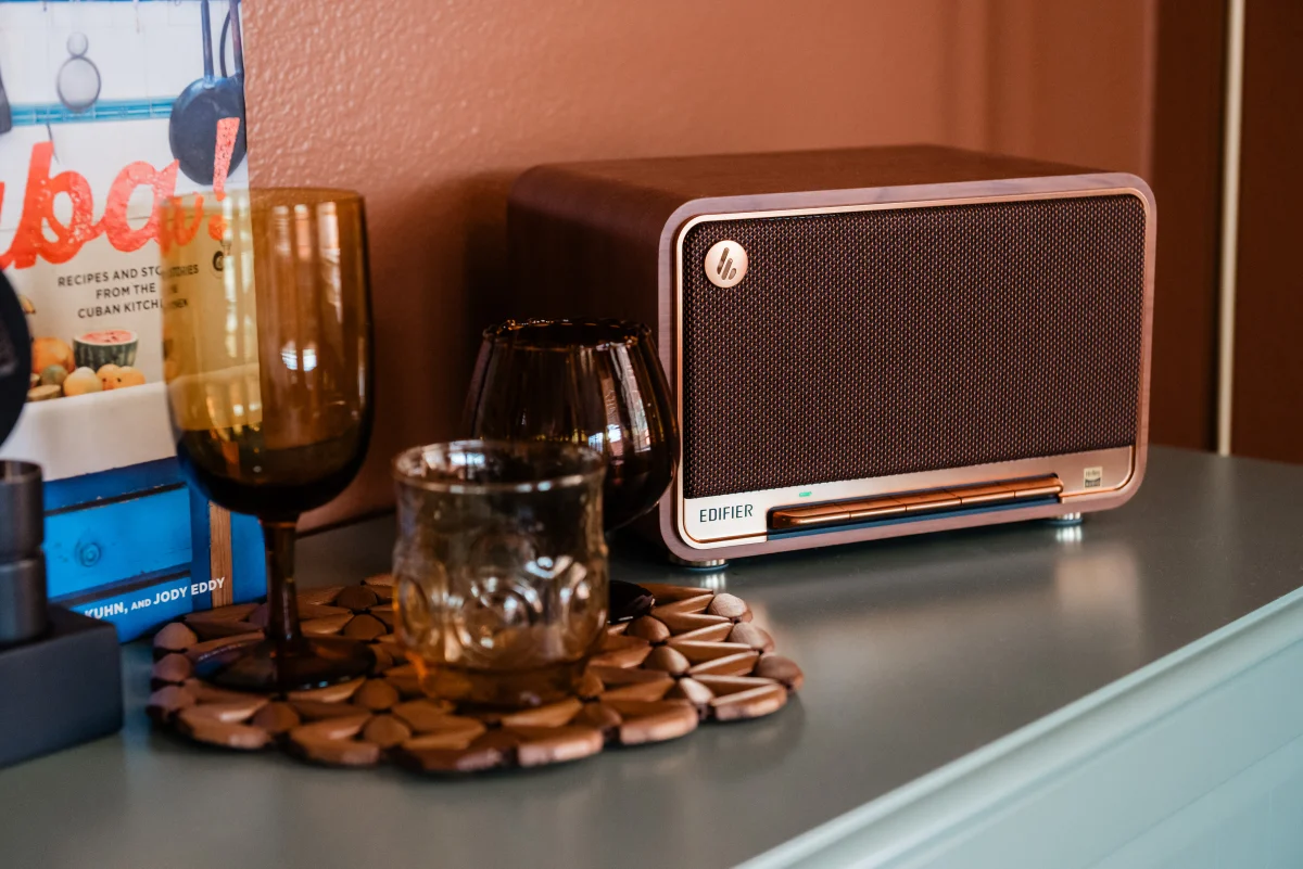 Terra Luz kitchen green bar credenza with Edifier speaker, amber glasses, and Cuba cookbook on terracotta wall