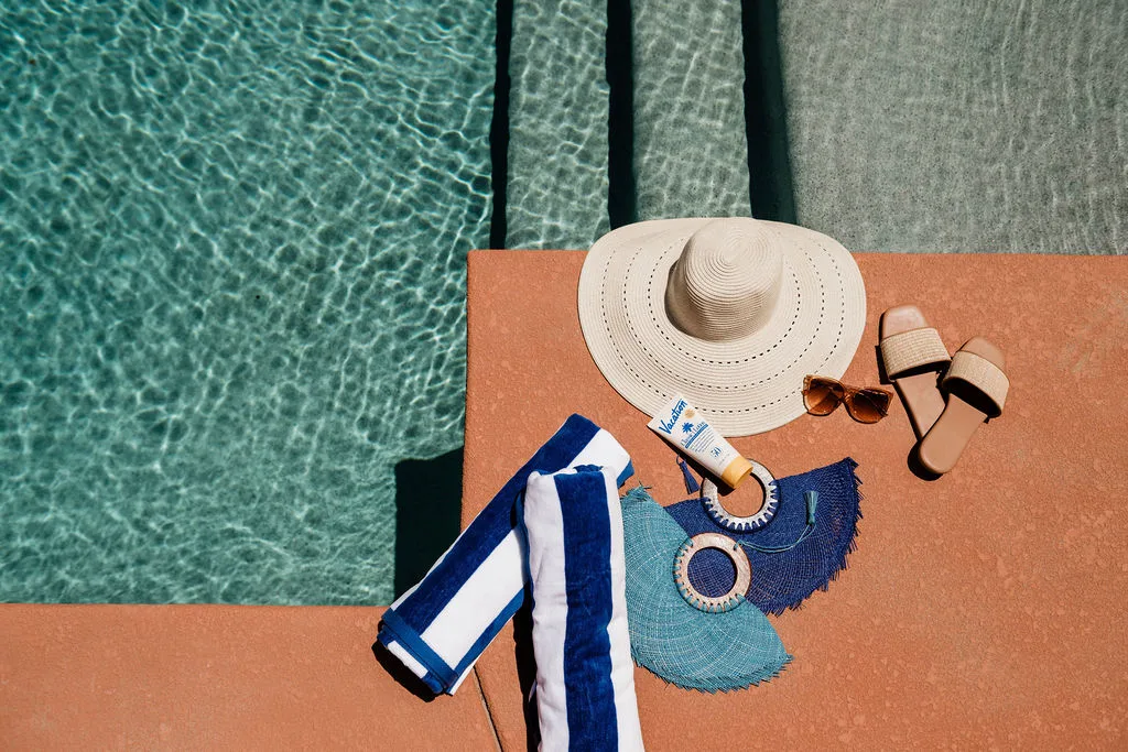 Terra Luz pool edge detail with sun shelf and Kahlo blue water at golden hour
