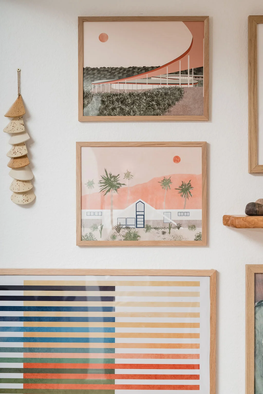 The Sundune Palm Springs living room art gallery wall with Palm Springs architecture prints in oak frames